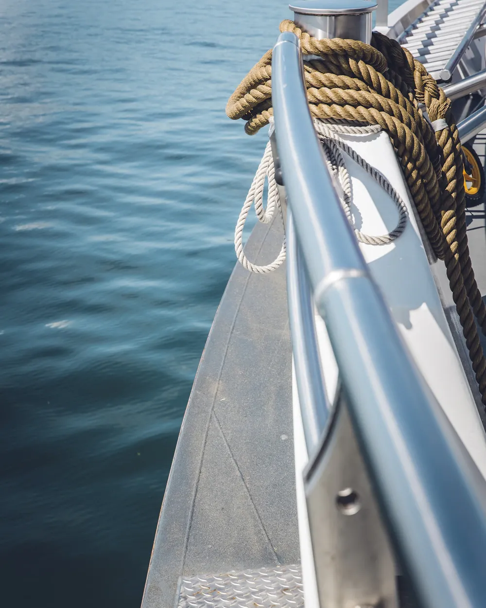Bow of a boat with mooring rope and open sea beyond