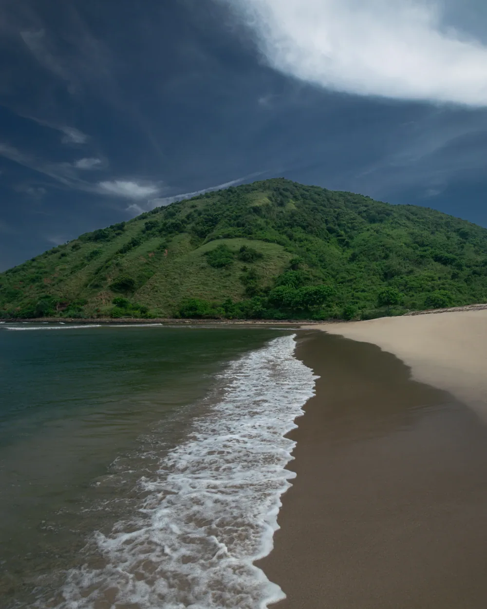 White-sand bay backed by green headlands on the south coast of Lombok