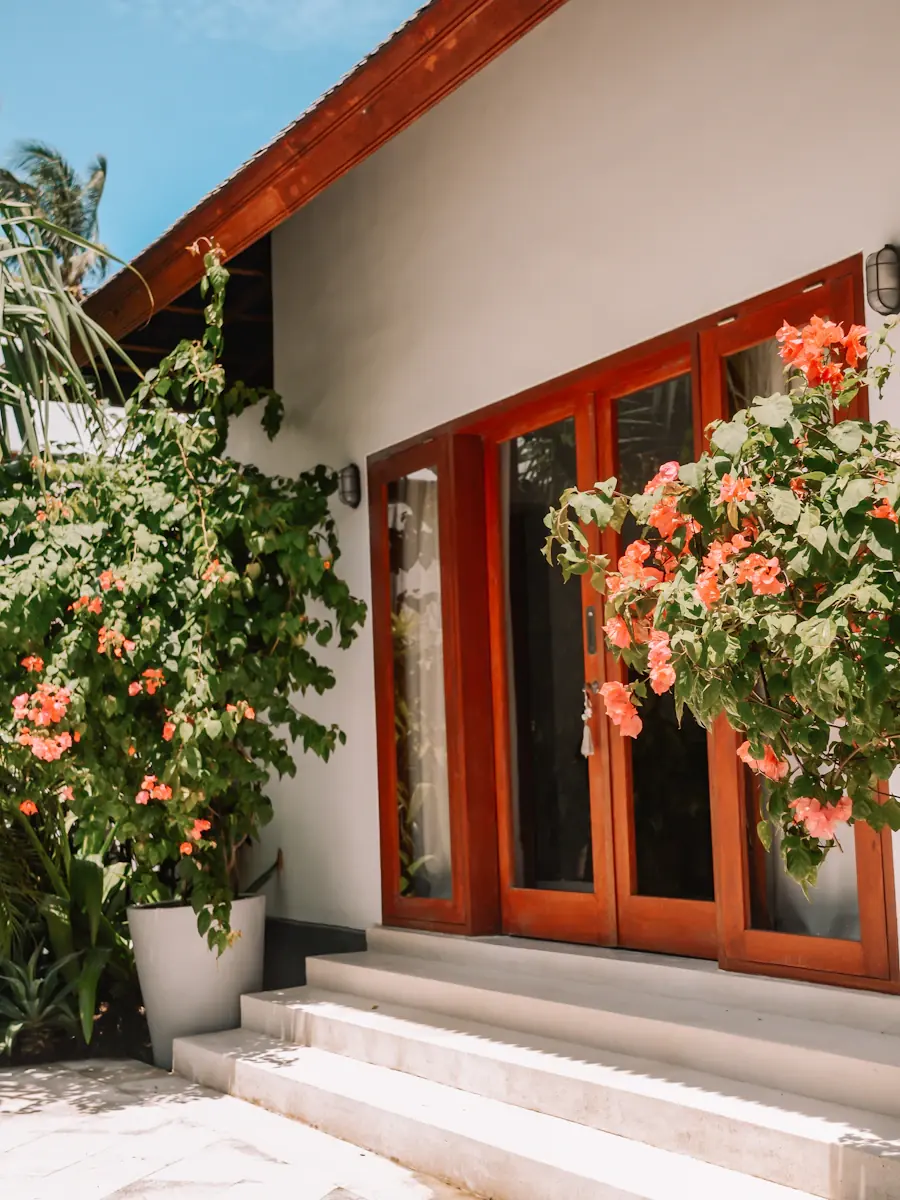 Bougainvillea beside the teak doors of a Lombok villa