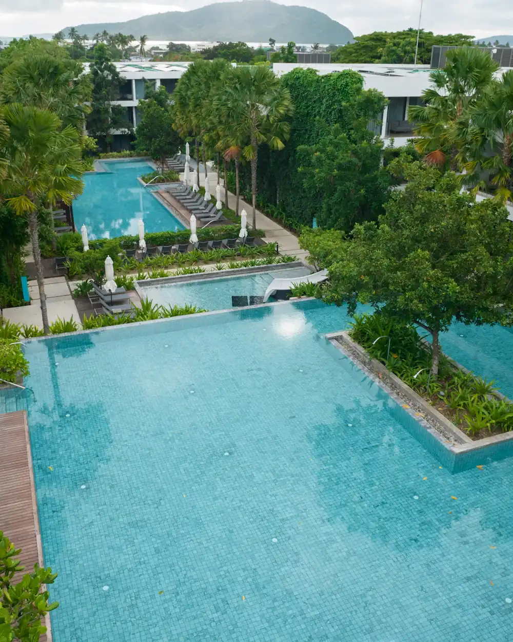 Resort swimming pools set among lush tropical greenery