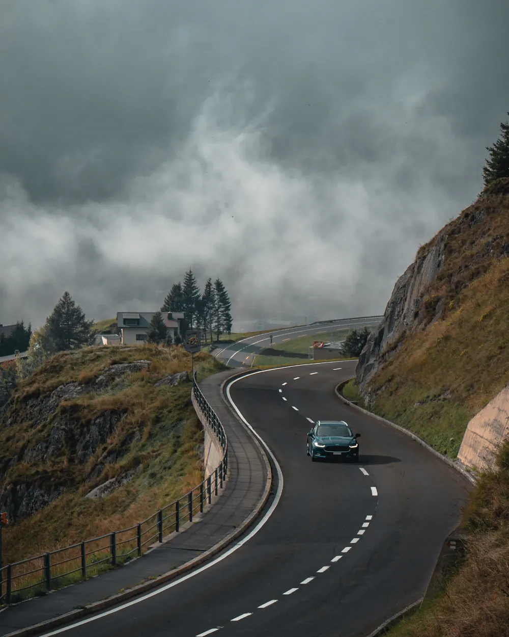 Coastal road curving along a green headland on Lombok's west coast