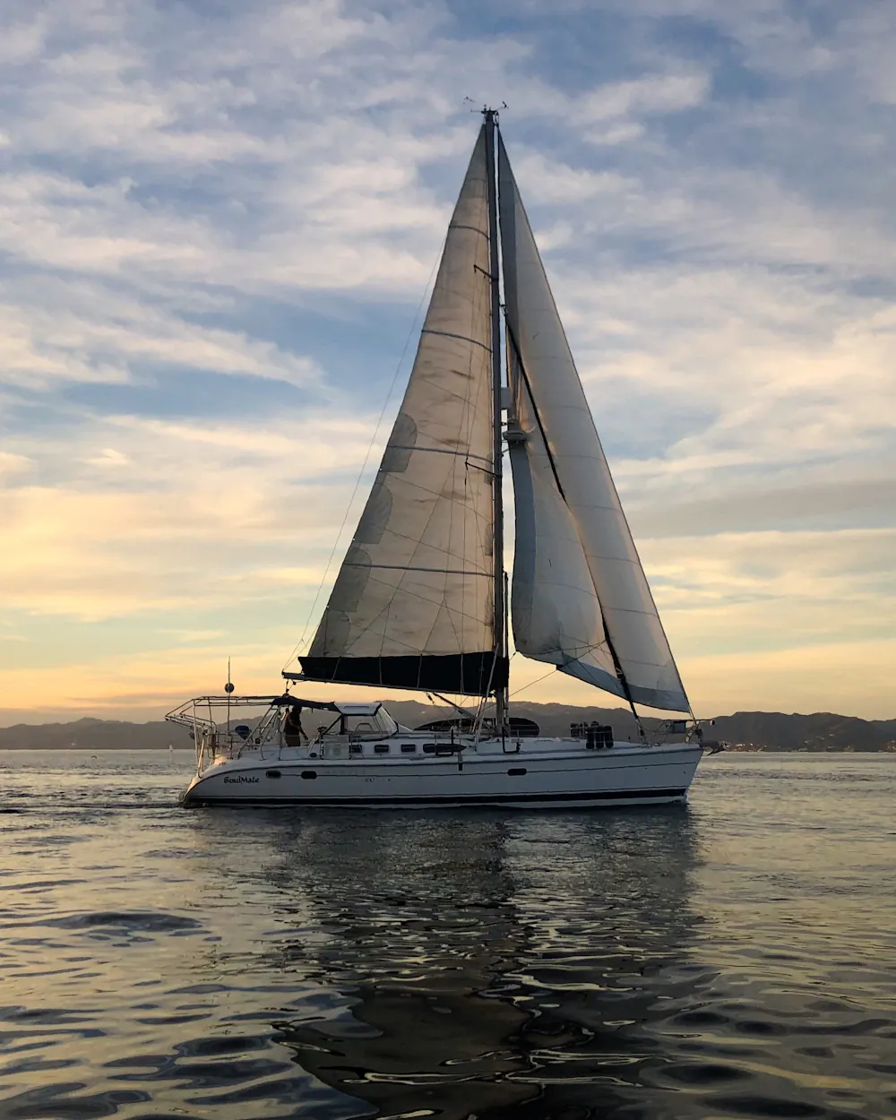 Sailing yacht under sail at golden hour