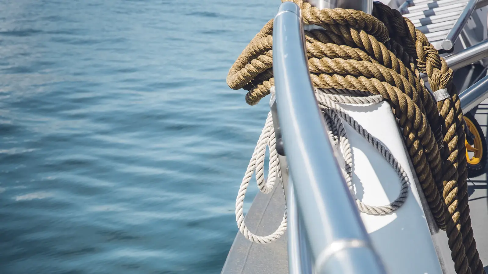 Bow of a boat with a mooring rope, open sea beyond