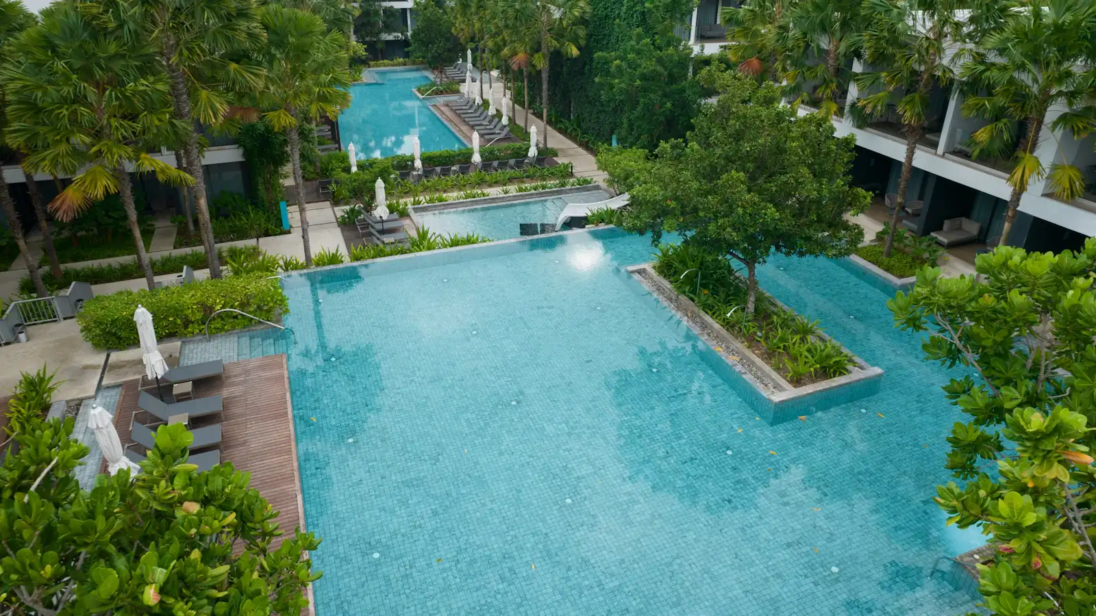 Resort swimming pools set among lush tropical greenery