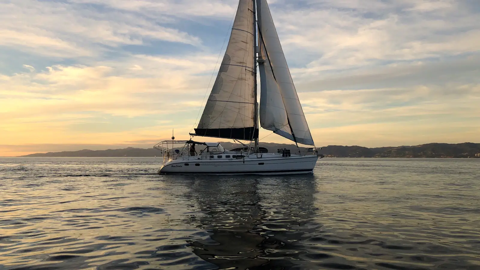 Sailing yacht under sail at golden hour