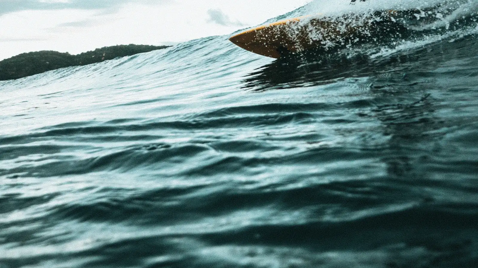 Surfer riding a clean, open wave face