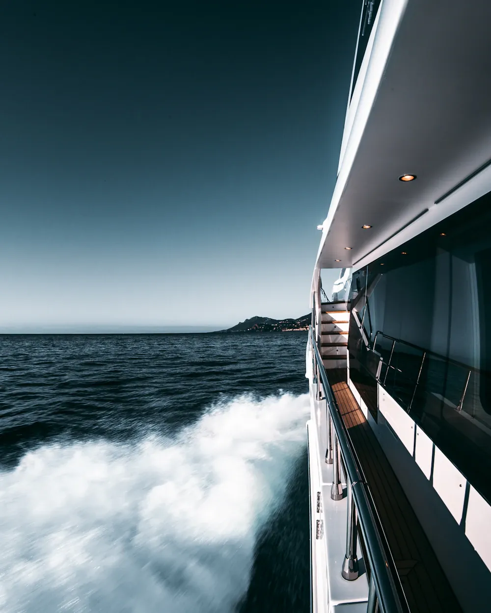White motor yacht hull cutting through open water