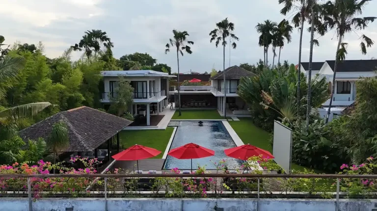 Resort terrace with red umbrellas above a pool