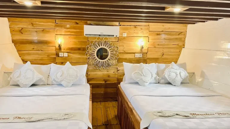 Timber-lined cabin with twin beds aboard a boat