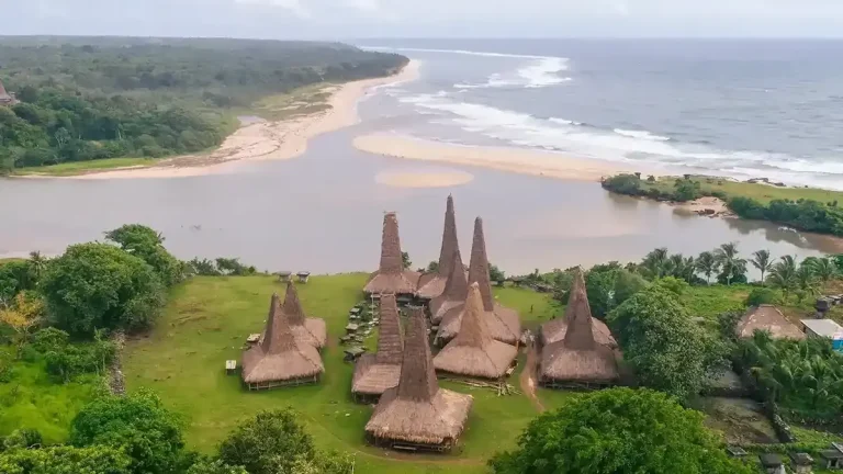 Traditional peaked-roof village beside a river mouth