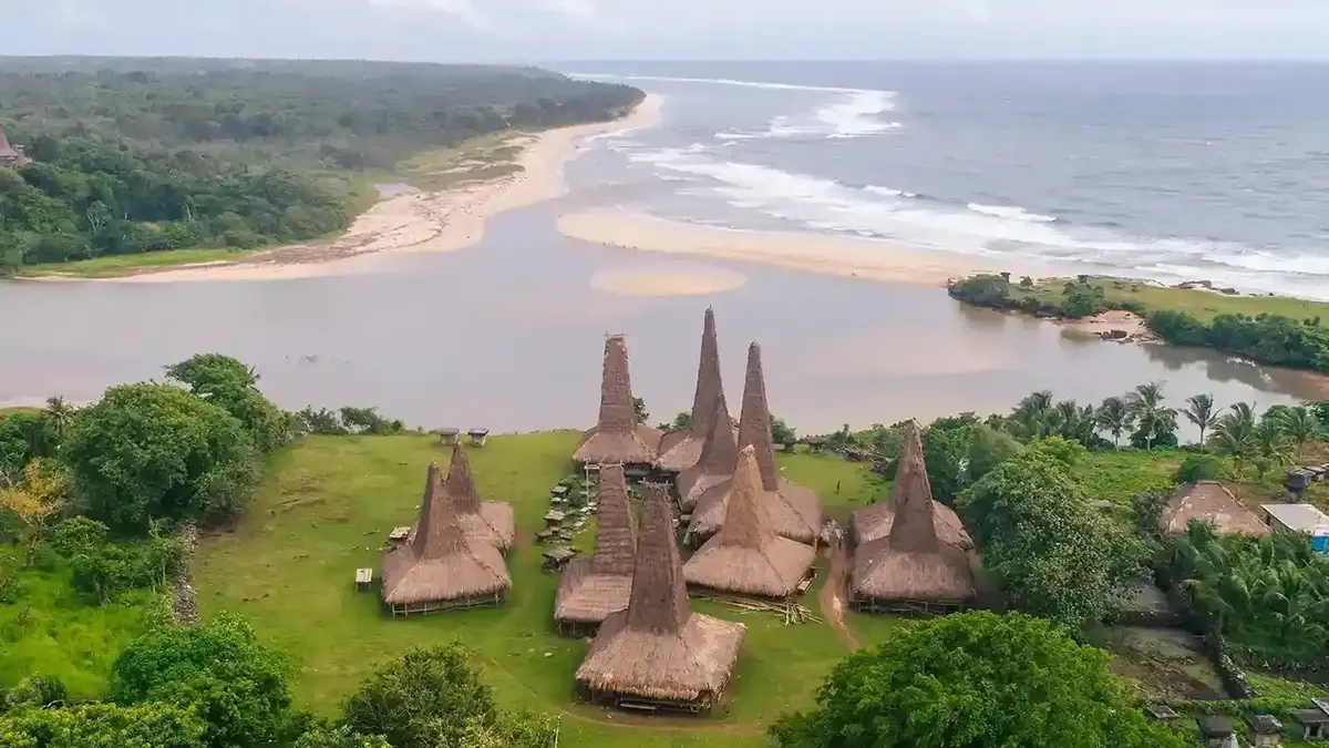 Traditional peaked-roof village beside a river mouth