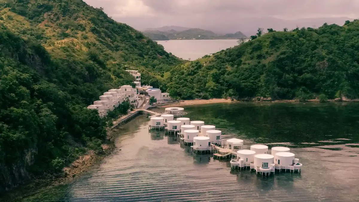 Overwater bungalows lining a sheltered green bay