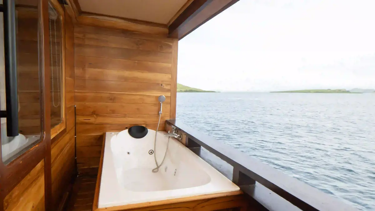 Guest cabin aboard a phinisi, timber panelling and made-up beds