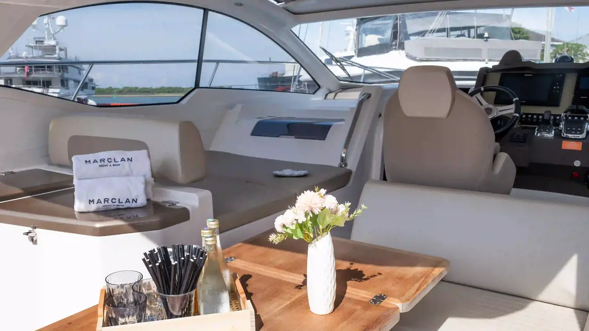 Crew laying out dinner service aboard a charter boat