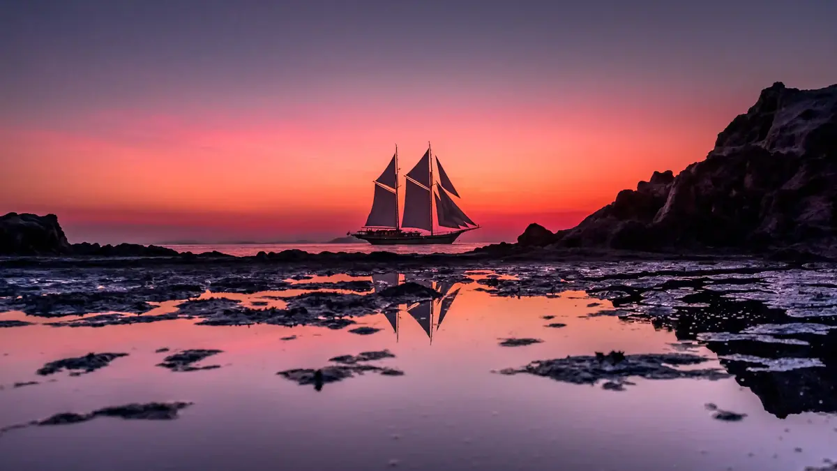 Sunset over the water seen from a boat at anchor