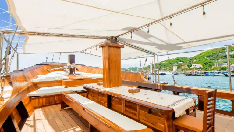 Crew laying out dinner service aboard a charter boat